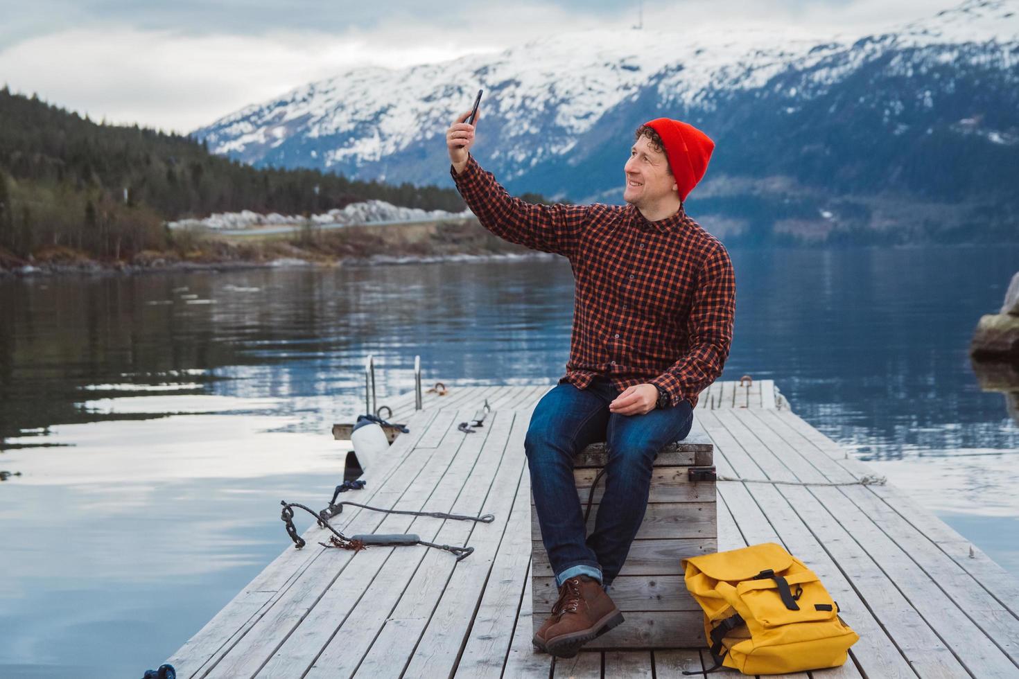 hombre viajero tomando autorretrato una foto con un teléfono inteligente