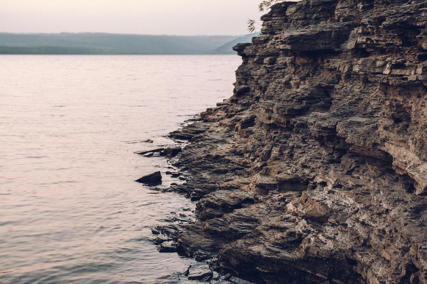 Texture of a rocky shore near the water. Rock pile background photo