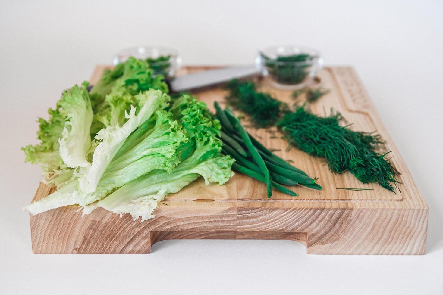 Cabbage on wooden board on a white background photo