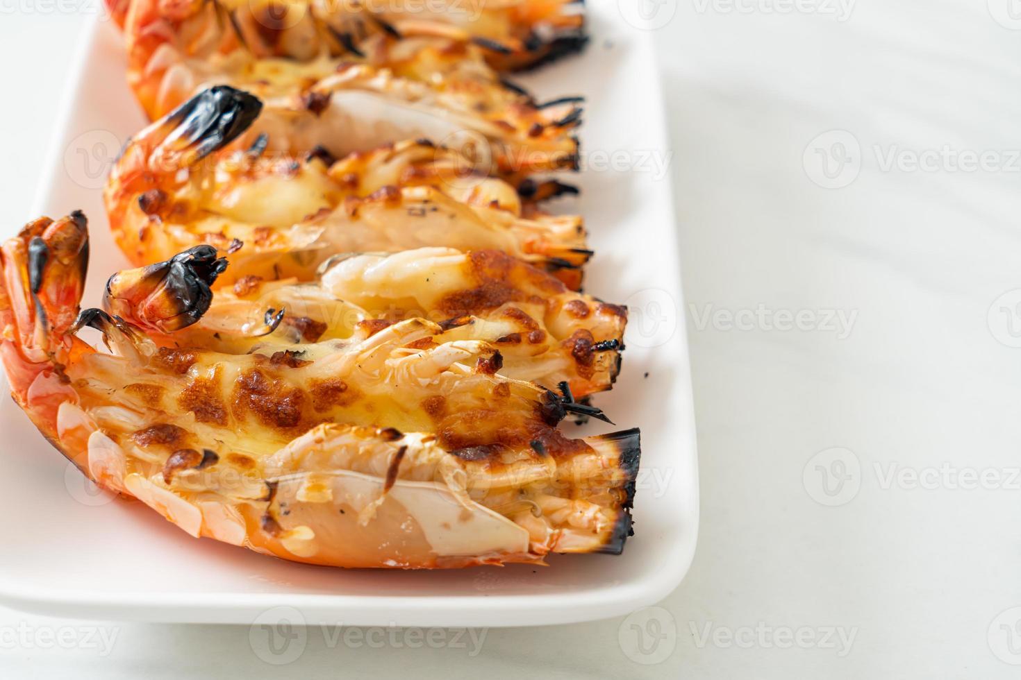 Grilled river prawns or shrimps with cheese - seafood style photo