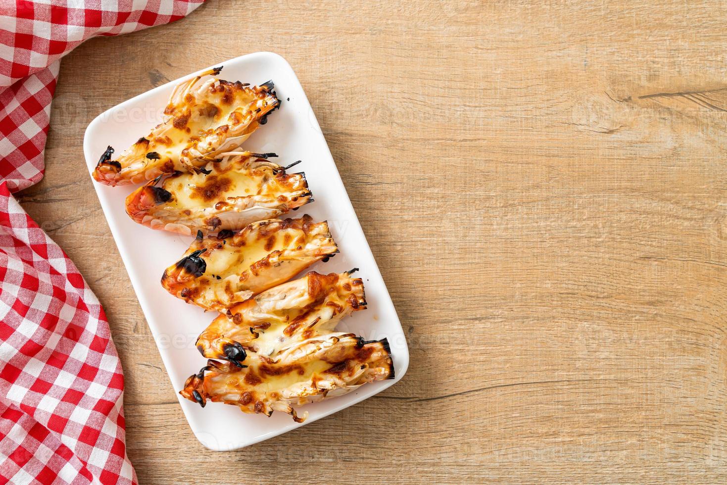 Grilled river prawns or shrimps with cheese - seafood style photo