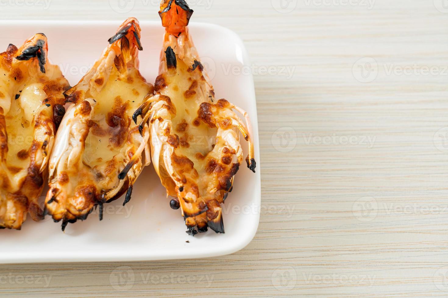 Grilled river prawns or shrimps with cheese - seafood style photo
