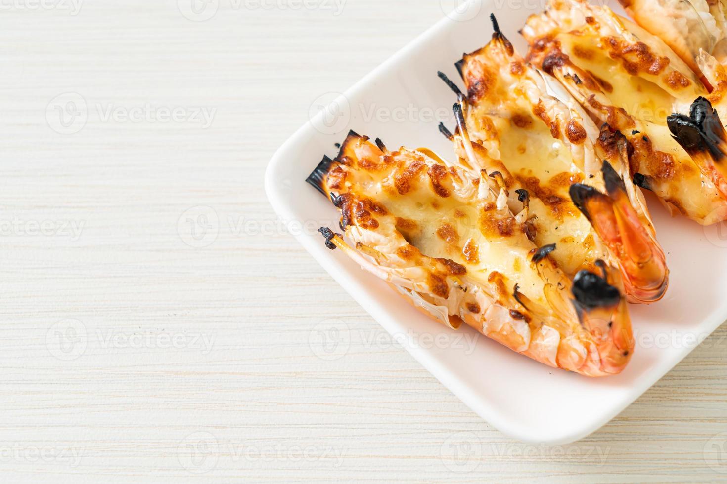 Grilled river prawns or shrimps with cheese - seafood style photo