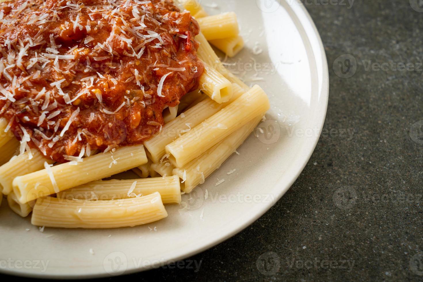 Rigatoni pasta with pork bolognese sauce - Italian food style photo