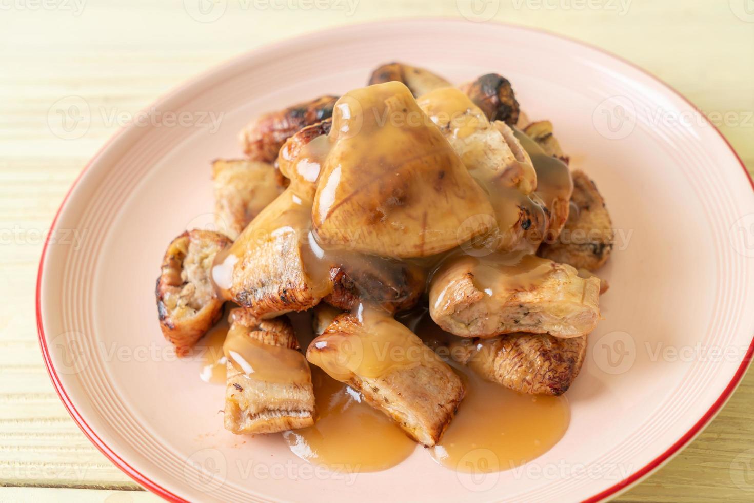 Grilled bananas with coconut caramel sauce on plate 3152959 Stock Photo at Vecteezy