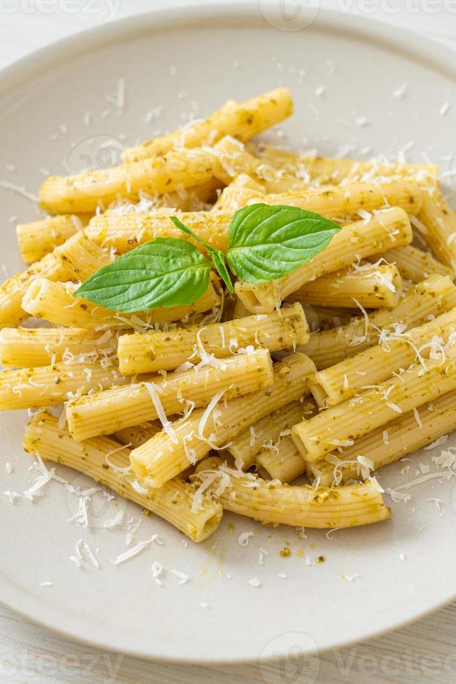 Pesto Rigatoni pasta with parmesan cheese - Italian food and vegetarian food style photo