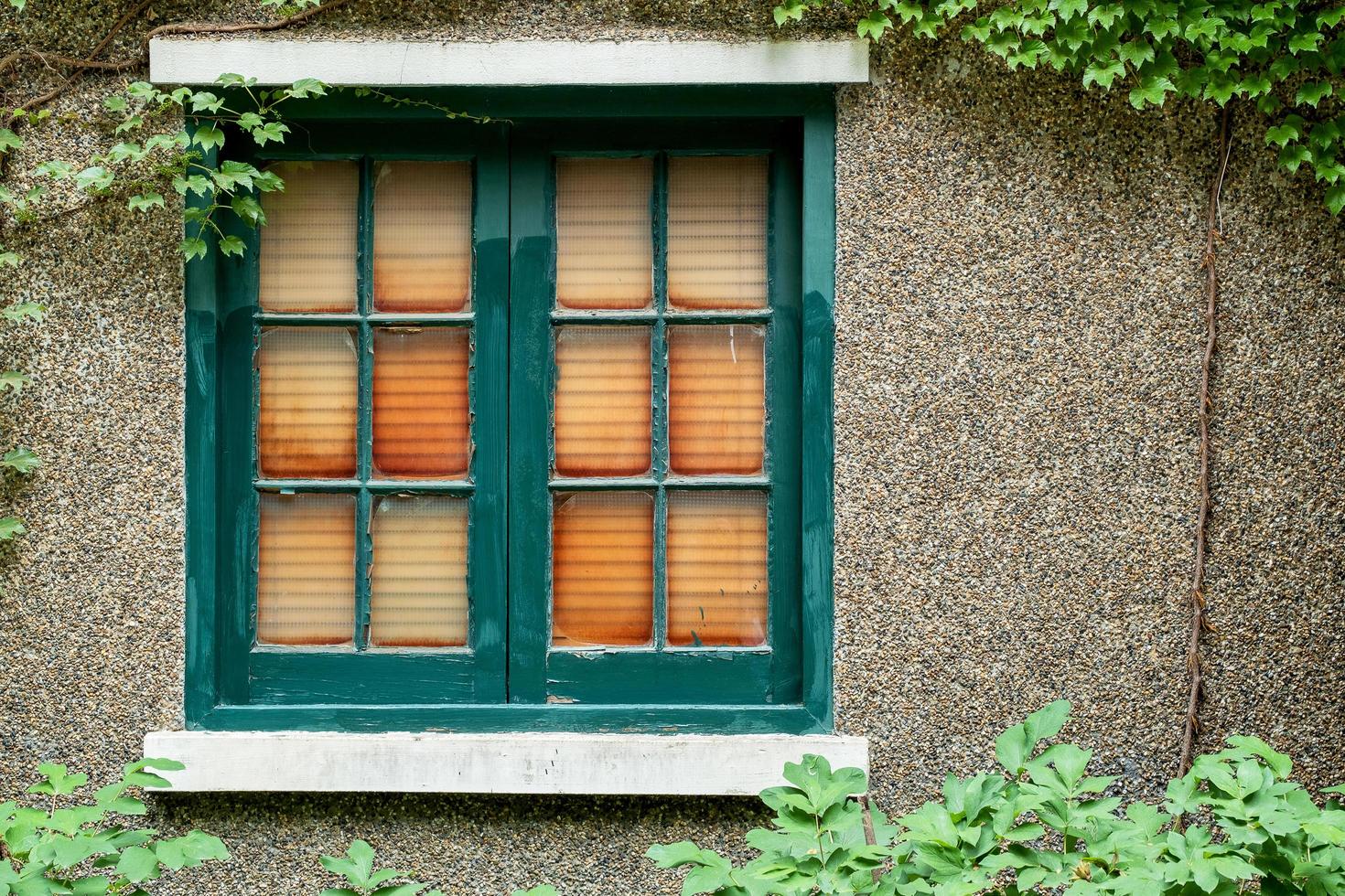 Antique wooden window frame on stone wall photo