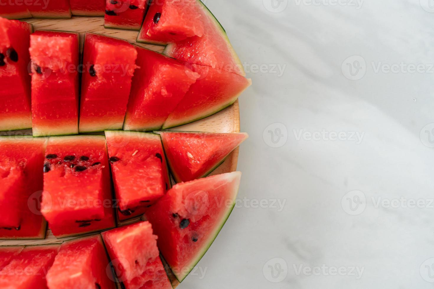 Fresh watermelon sliced on wooden plate photo