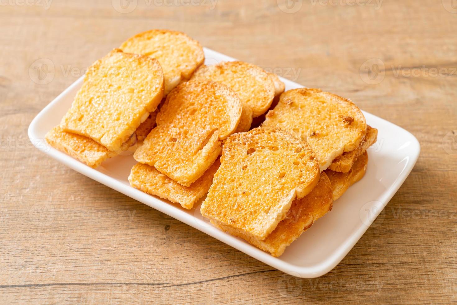 baked crispy bread with butter and sugar photo