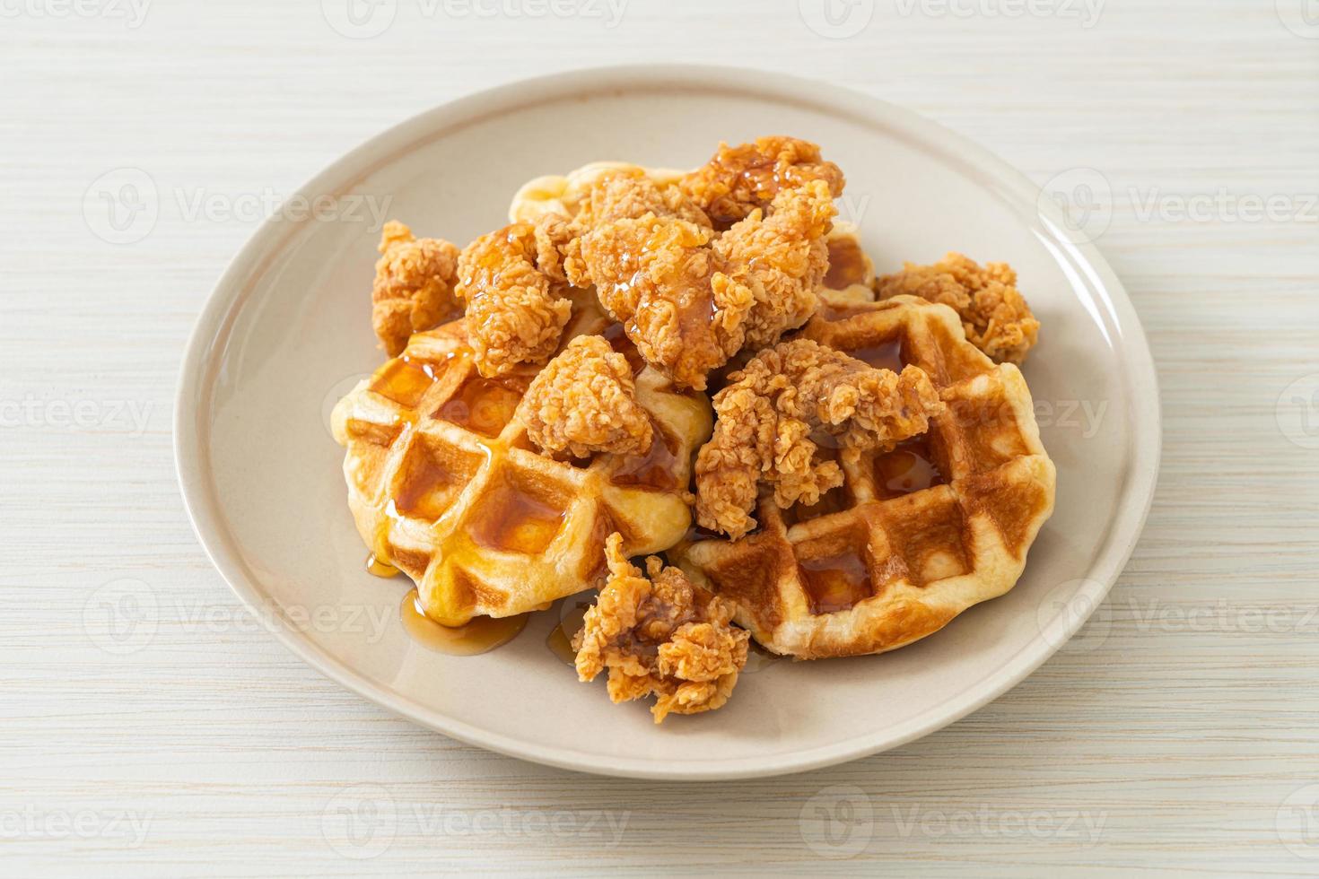 Homemade fried chicken waffle with honey or maple syrup photo