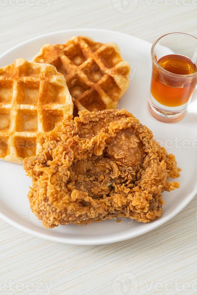 Homemade fried chicken waffle with honey or maple syrup photo