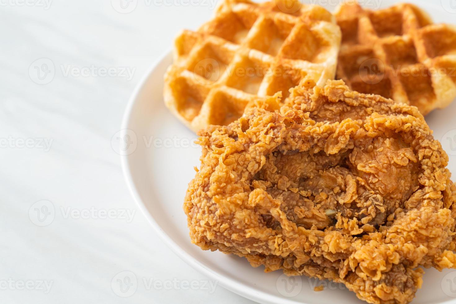 Homemade fried chicken waffle with honey or maple syrup photo