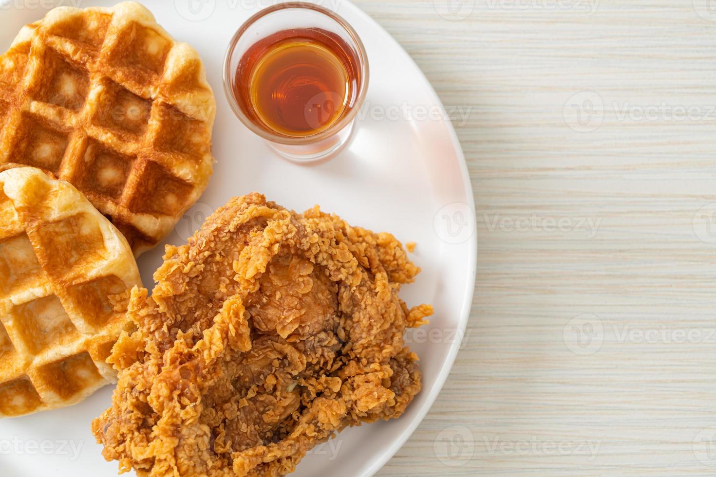 Homemade fried chicken waffle with honey or maple syrup photo