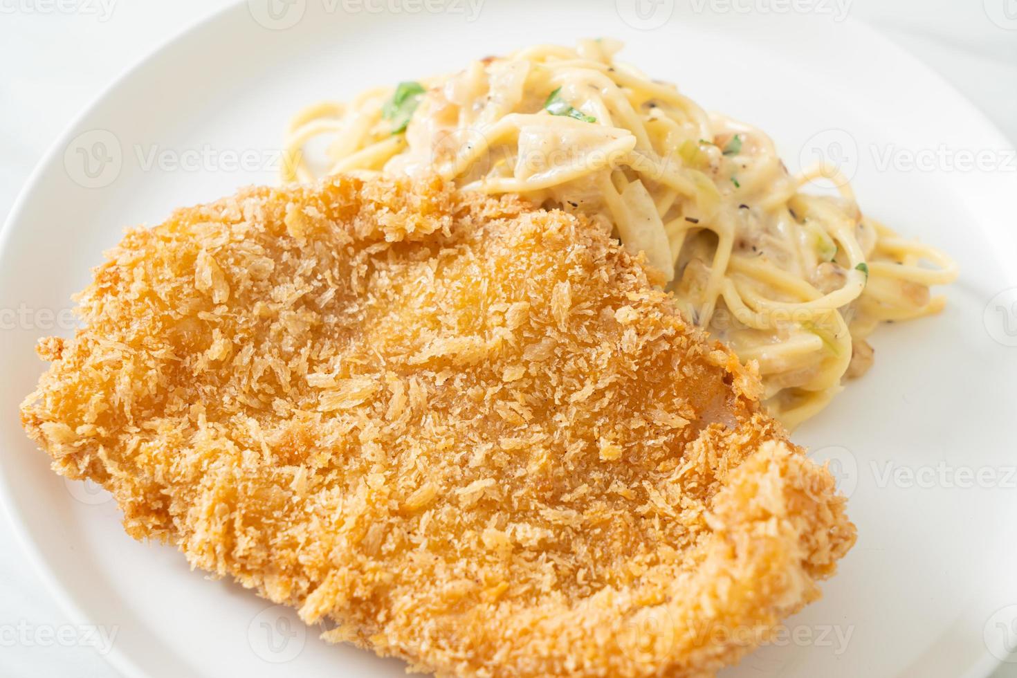 Homemade spaghetti pasta white cream sauce with fried fish photo