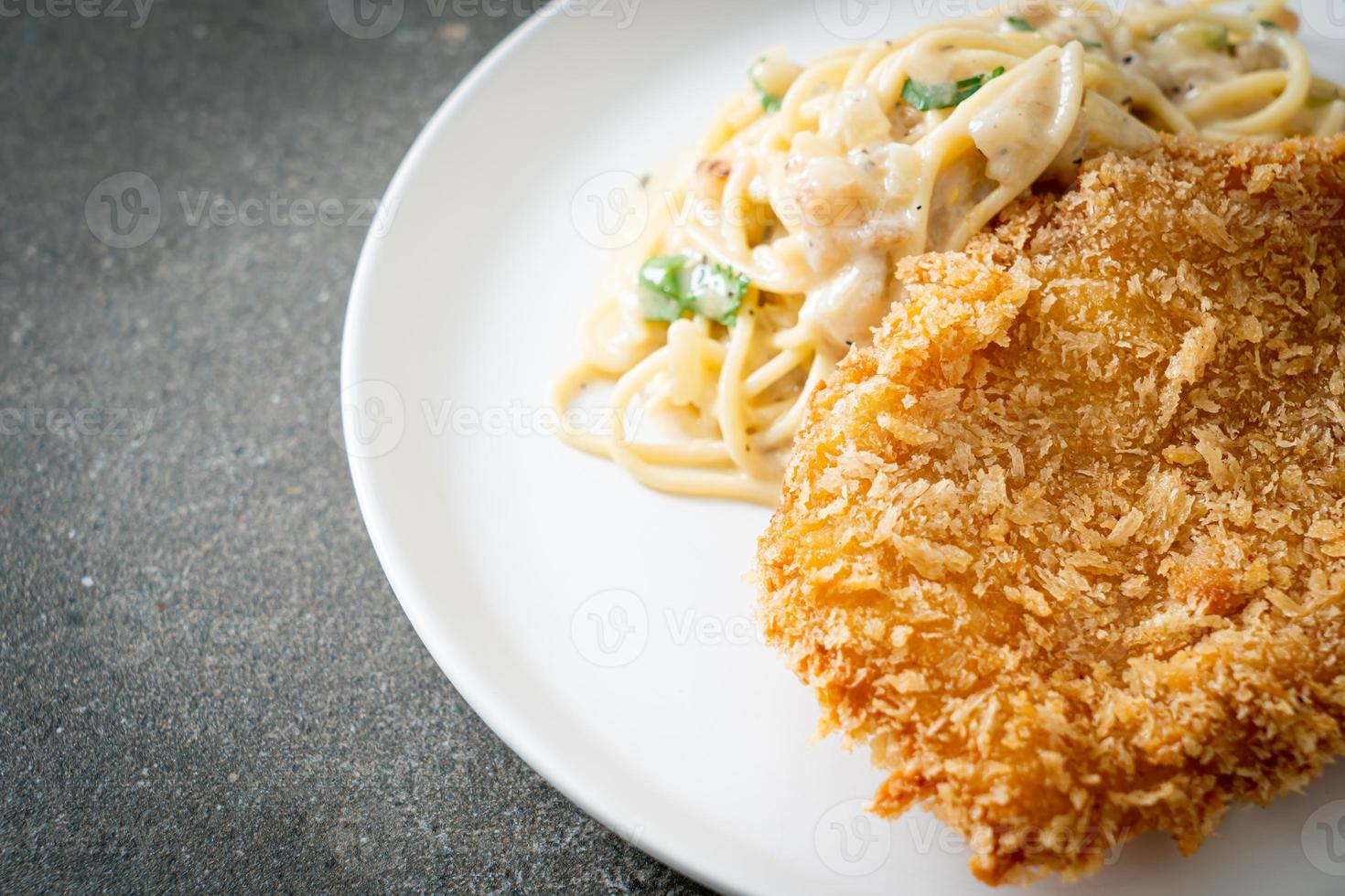 Pasta de espagueti casera salsa de crema blanca con pescado frito foto