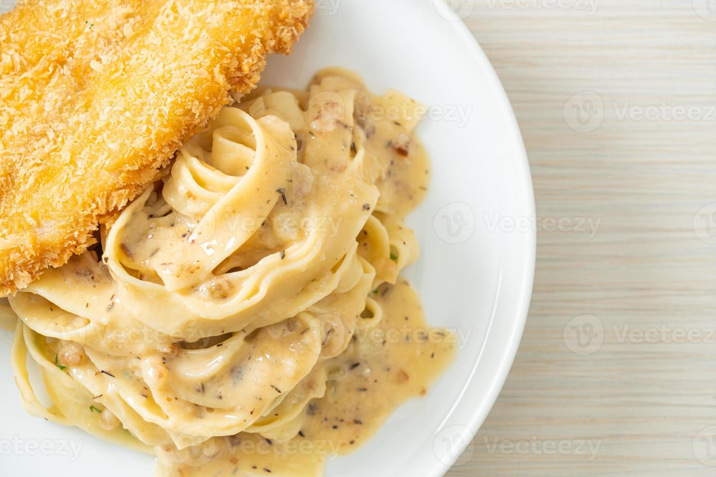 Homemade fettuccine pasta white cream sauce with fried fish photo