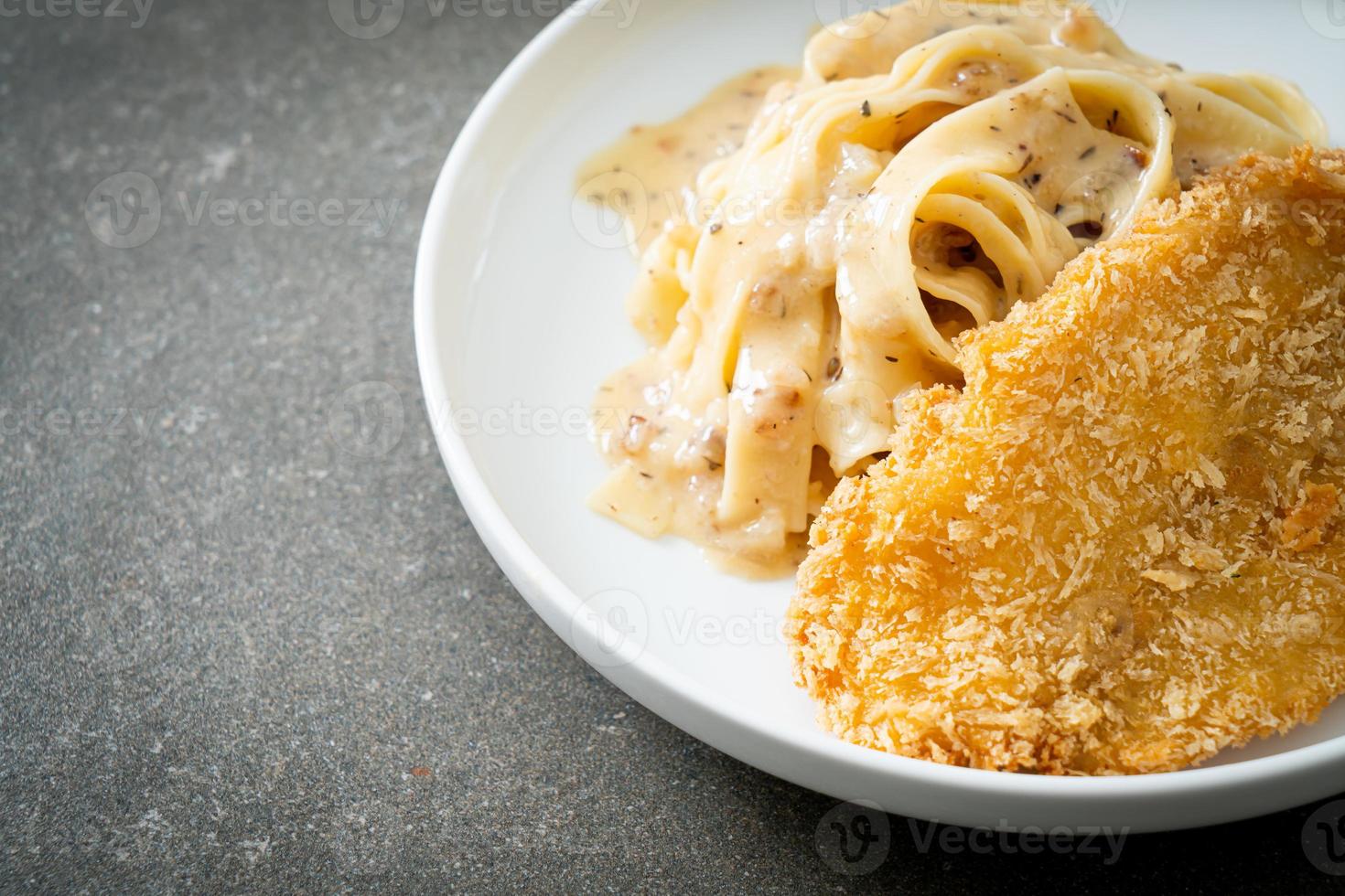 Homemade fettuccine pasta white cream sauce with fried fish photo