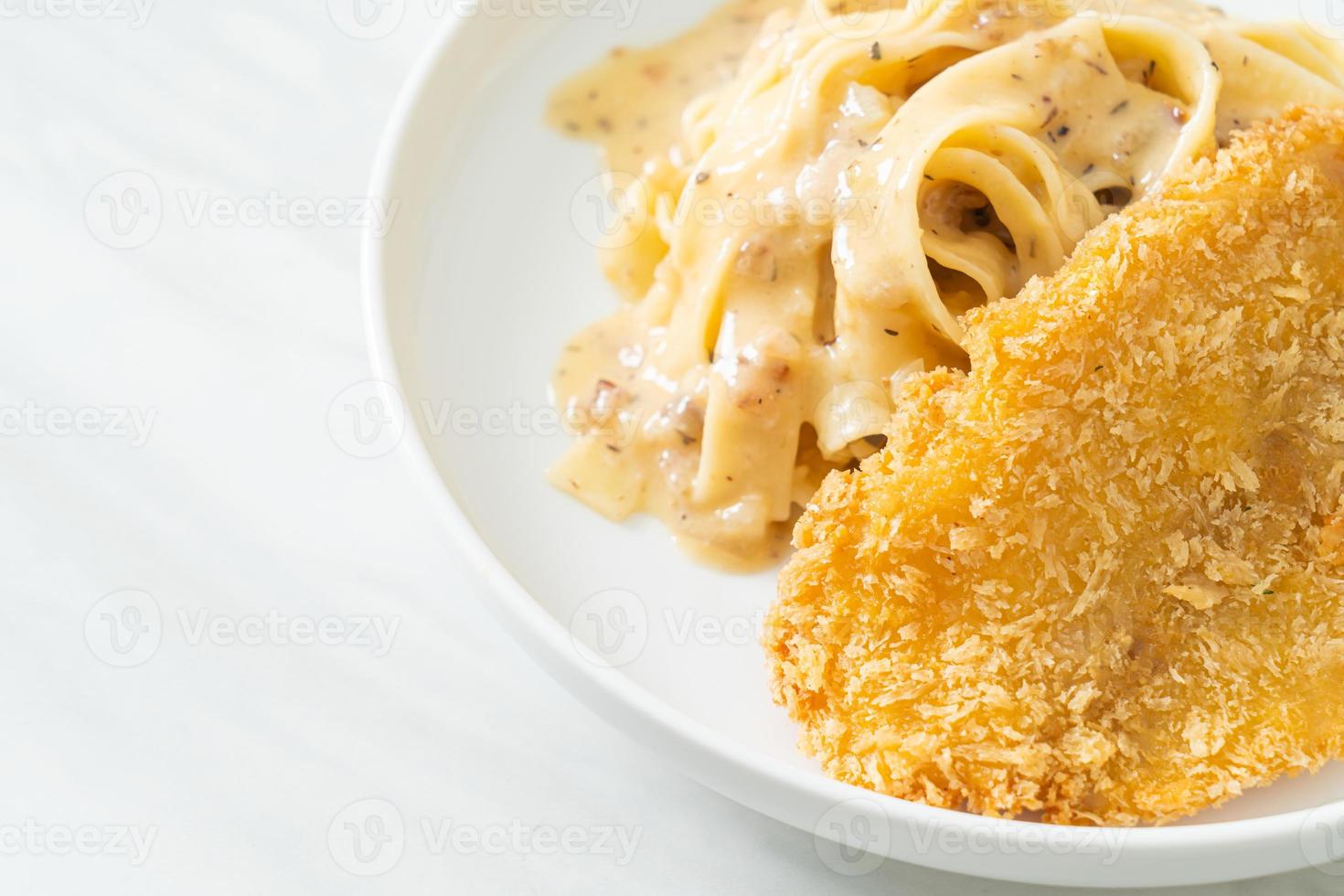 Homemade fettuccine pasta white cream sauce with fried fish photo