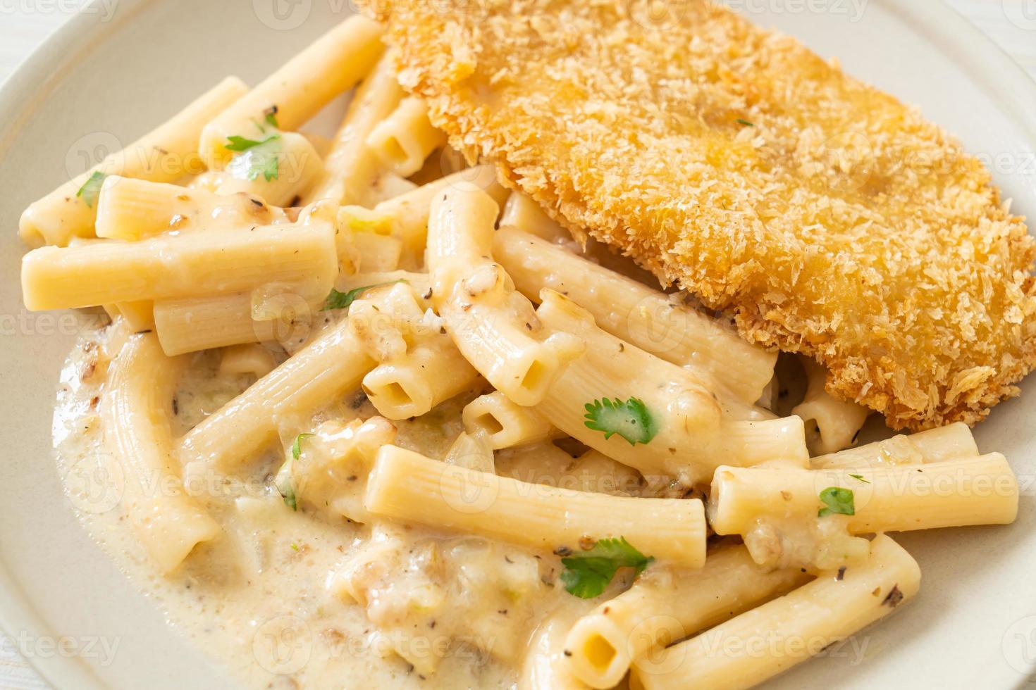 Homemade quadrotto penne pasta white cream sauce with fried fish photo