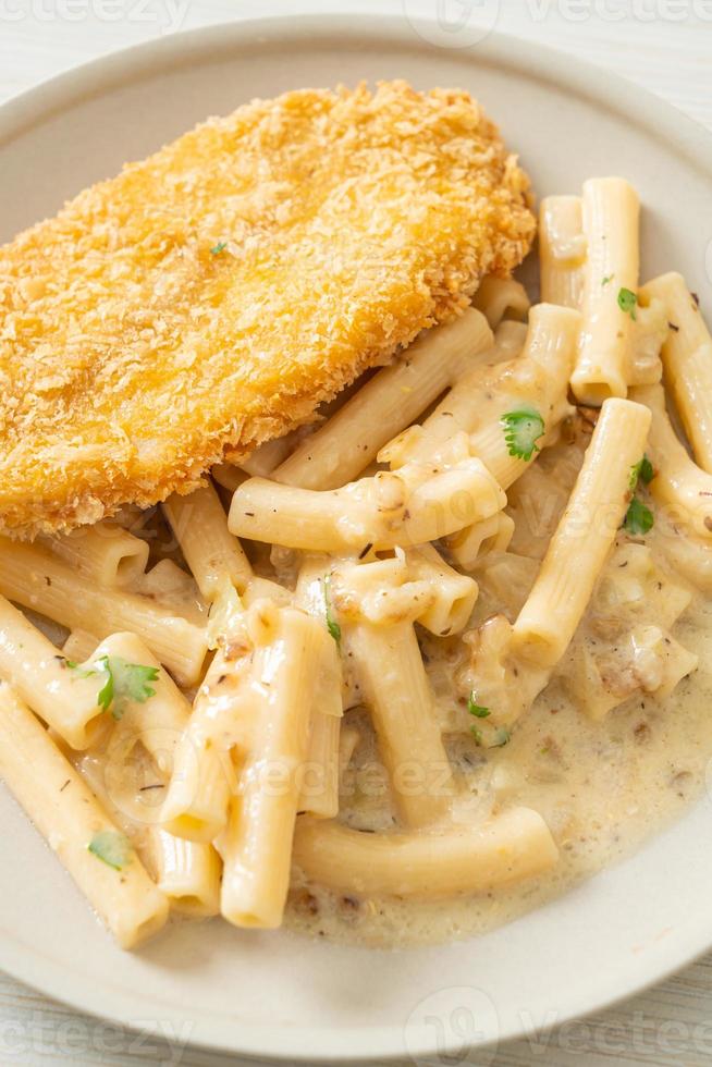 Homemade quadrotto penne pasta white cream sauce with fried fish photo