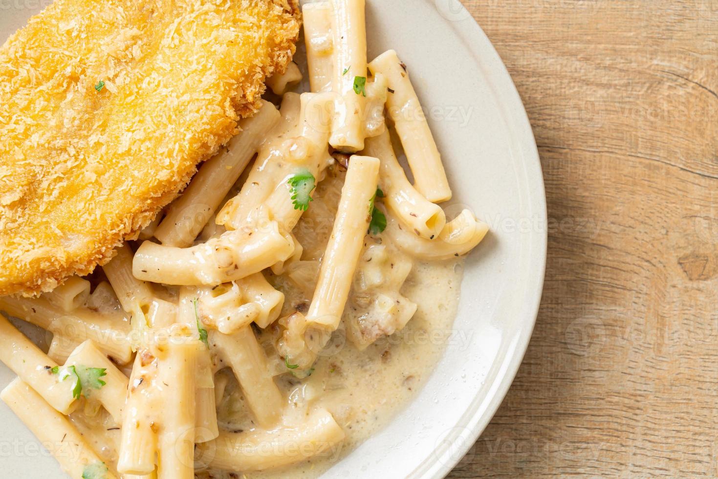 Homemade quadrotto penne pasta white cream sauce with fried fish photo