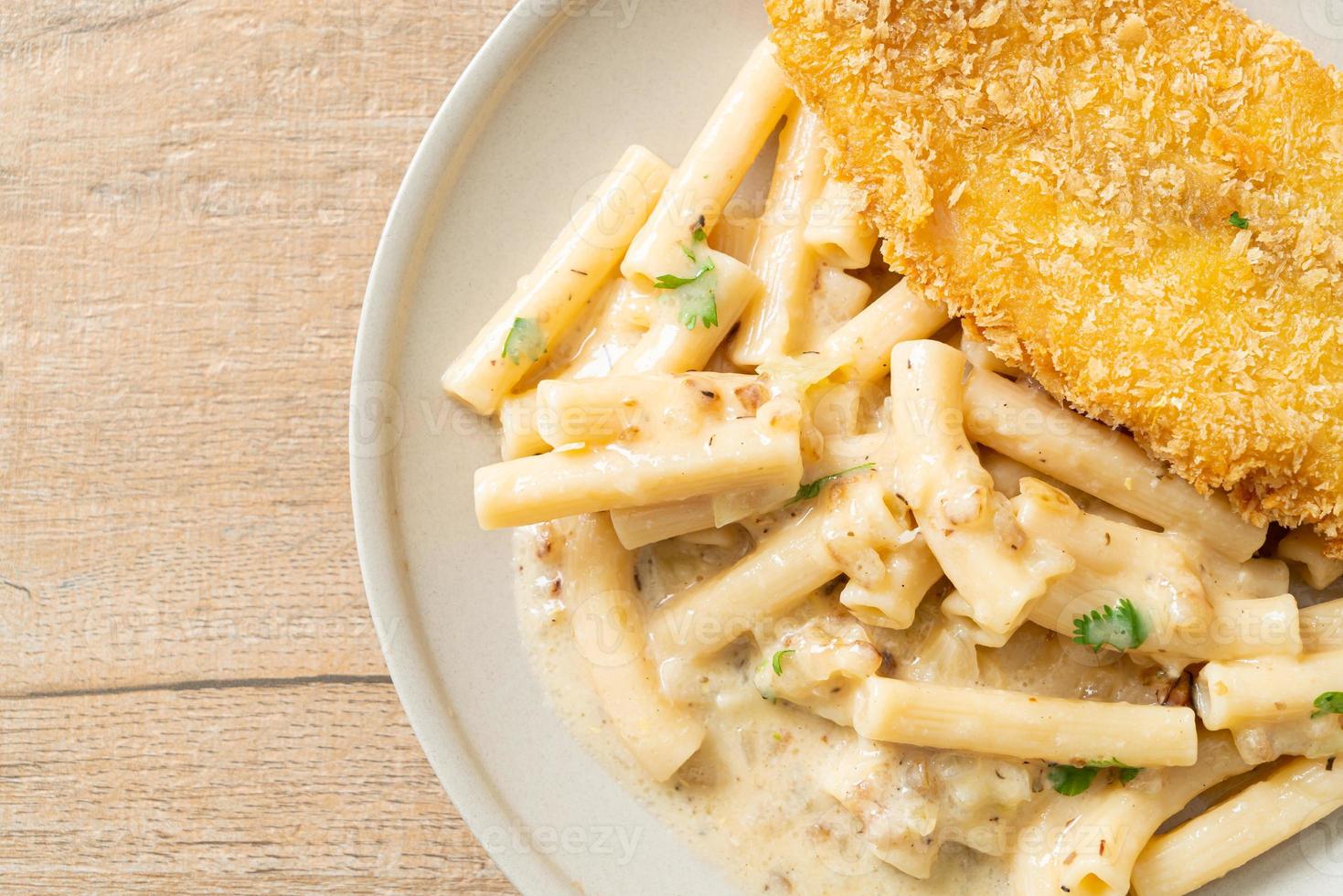 Homemade quadrotto penne pasta white cream sauce with fried fish photo