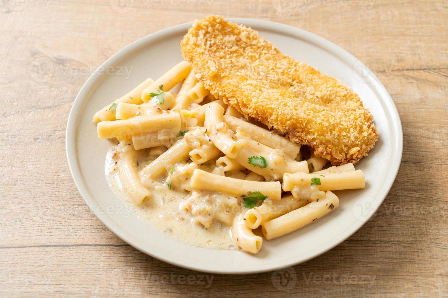 Homemade quadrotto penne pasta white cream sauce with fried fish photo