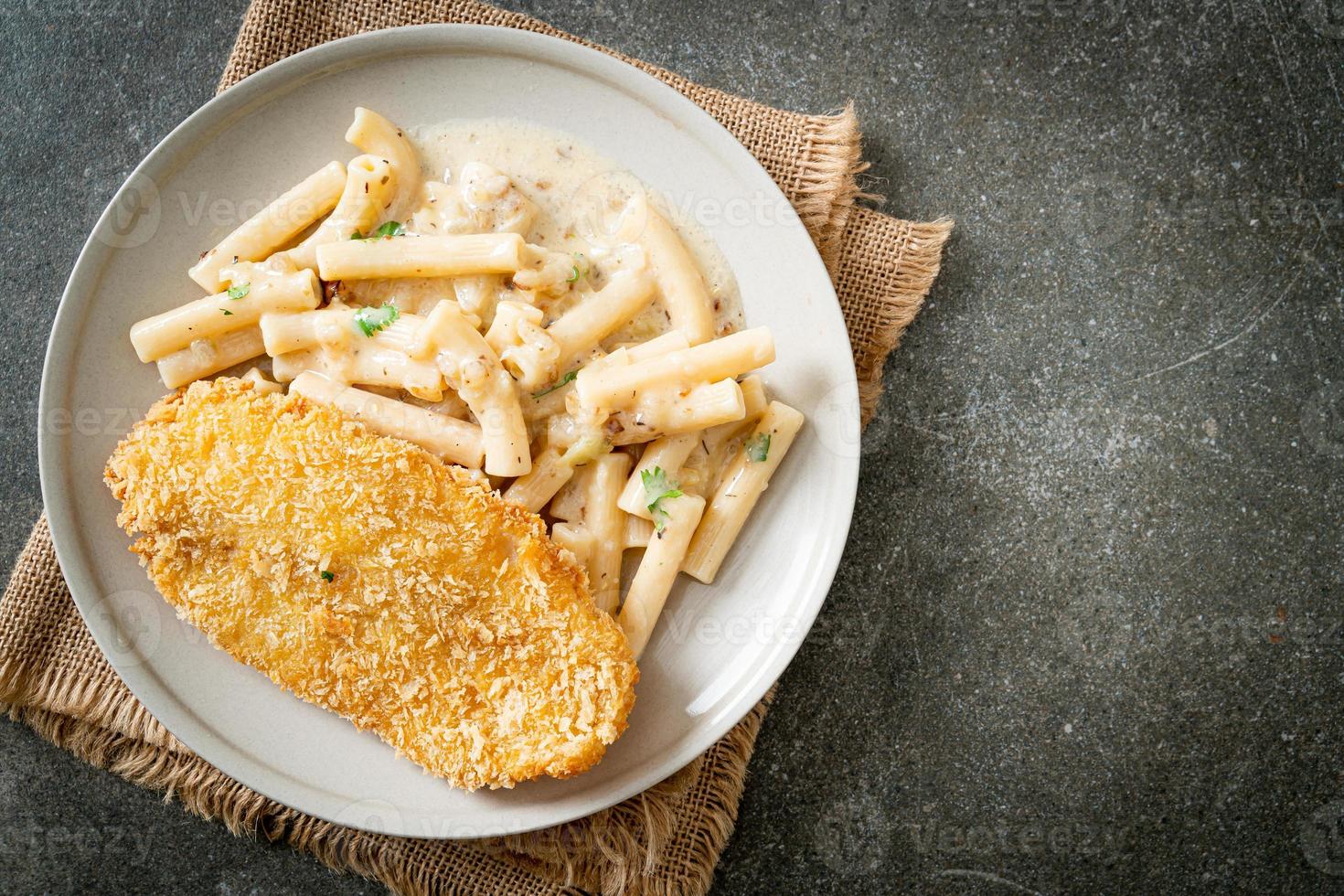 Homemade quadrotto penne pasta white cream sauce with fried fish photo