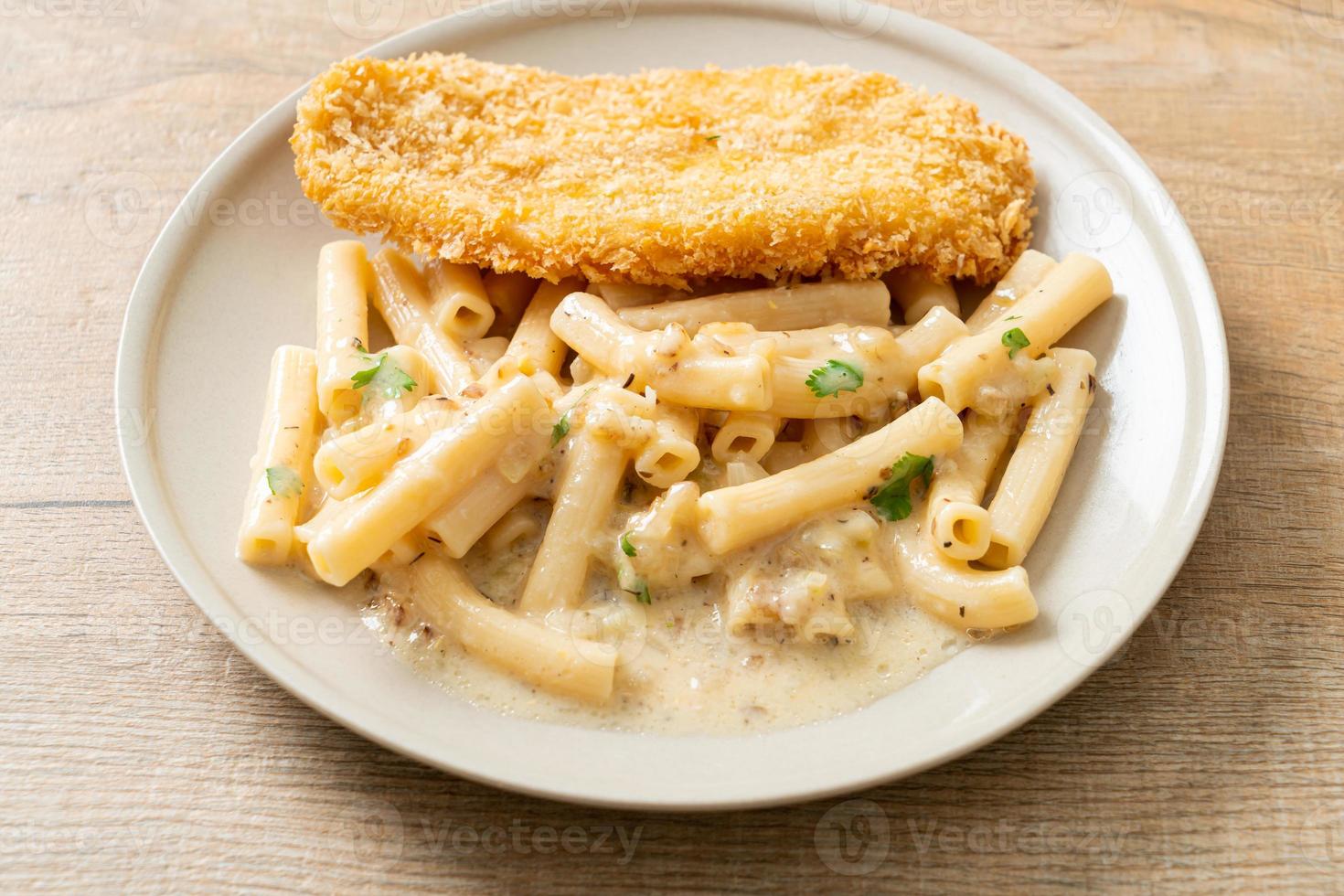 Homemade quadrotto penne pasta white cream sauce with fried fish photo