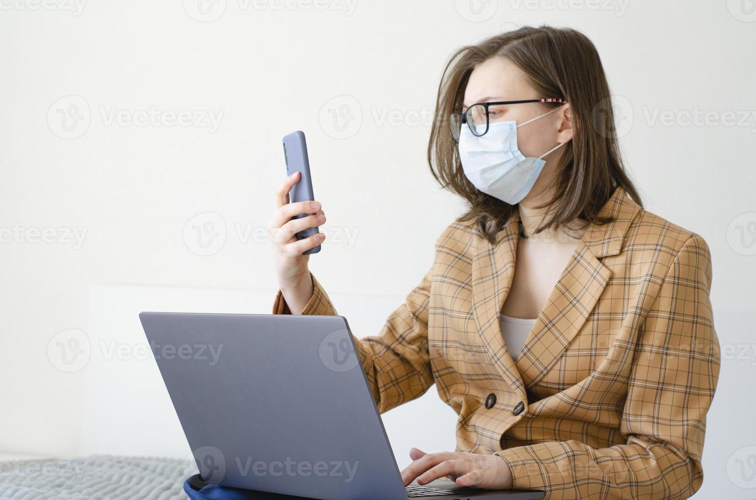 Coronavirus. Quarantine. Business lady solves work issues remotely. photo