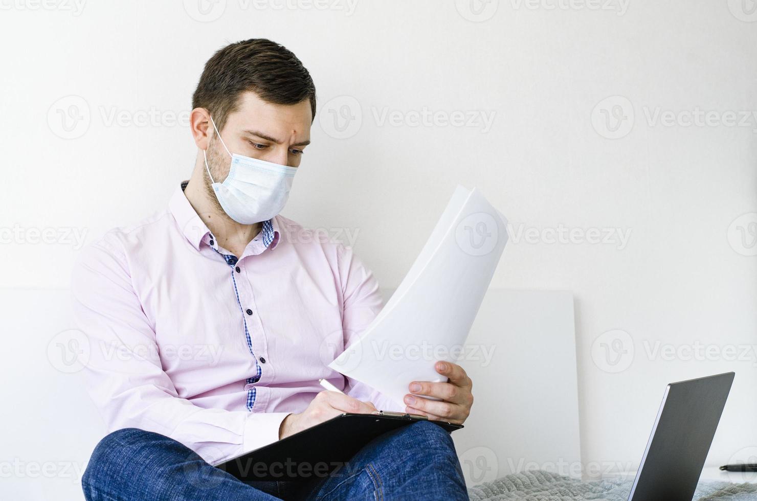 A man in a shirt and jeans solves work issues remotely. photo