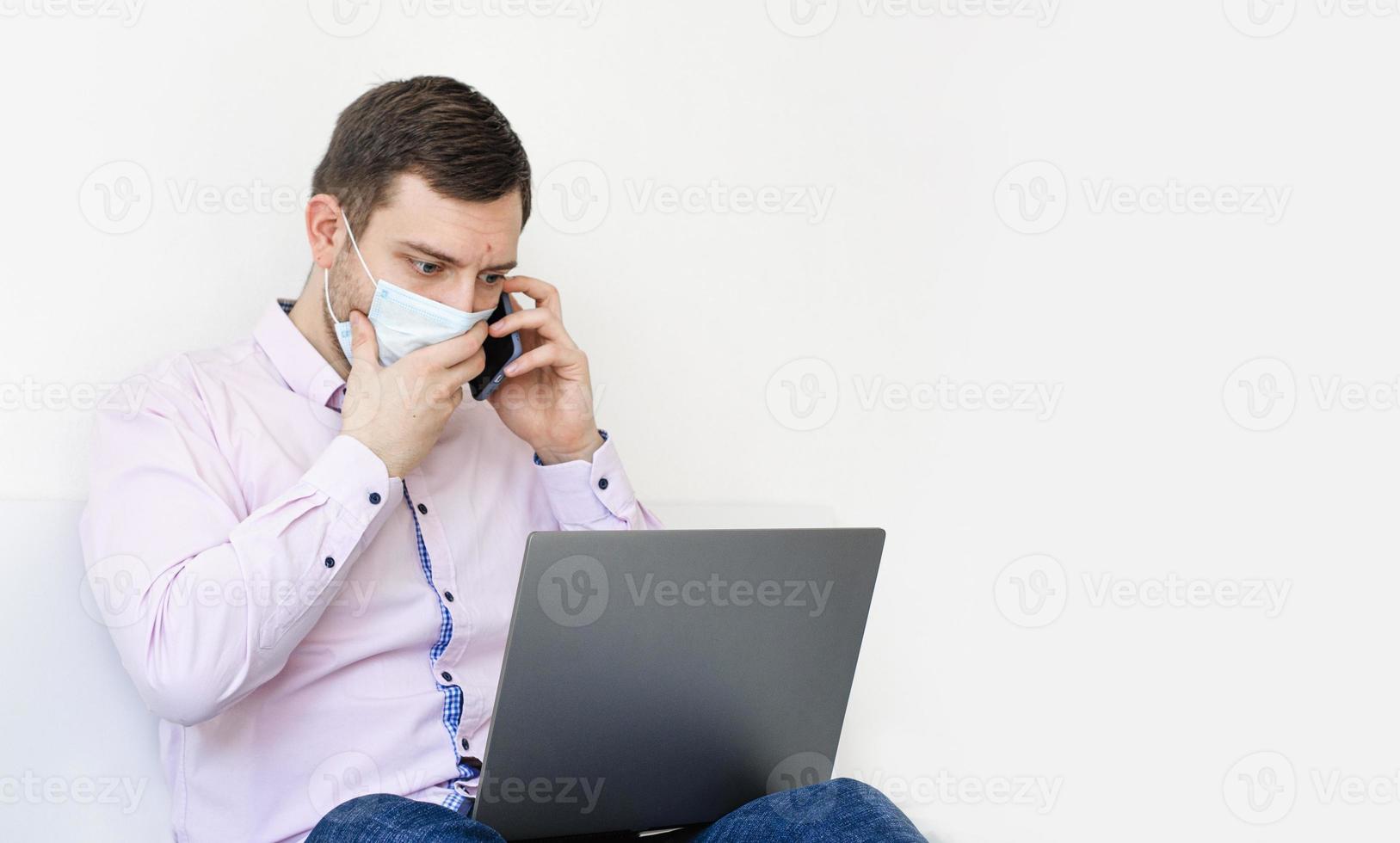 A man in a shirt and jeans solves work issues remotely. photo