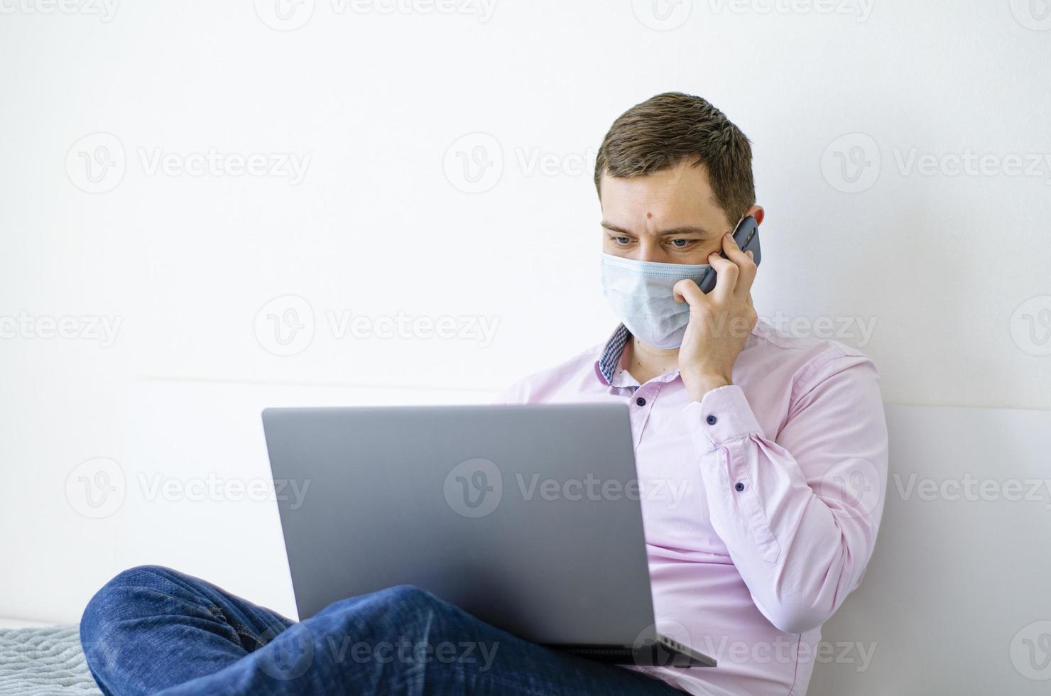 A man in a shirt and jeans solves work issues remotely. photo