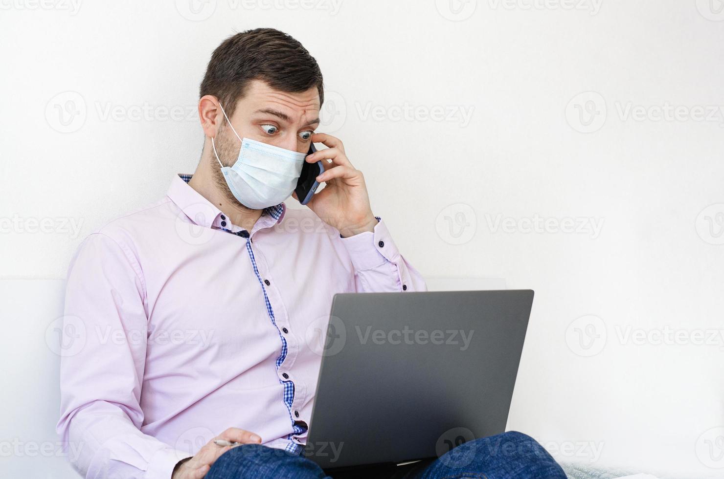 A man in a shirt and jeans solves work issues remotely. photo