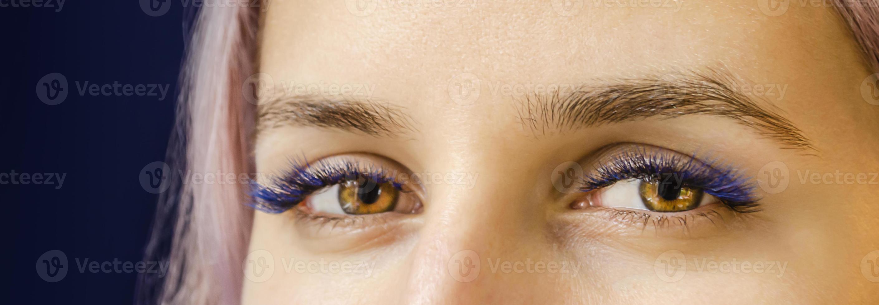 The lashes are black with splashes of blue. photo