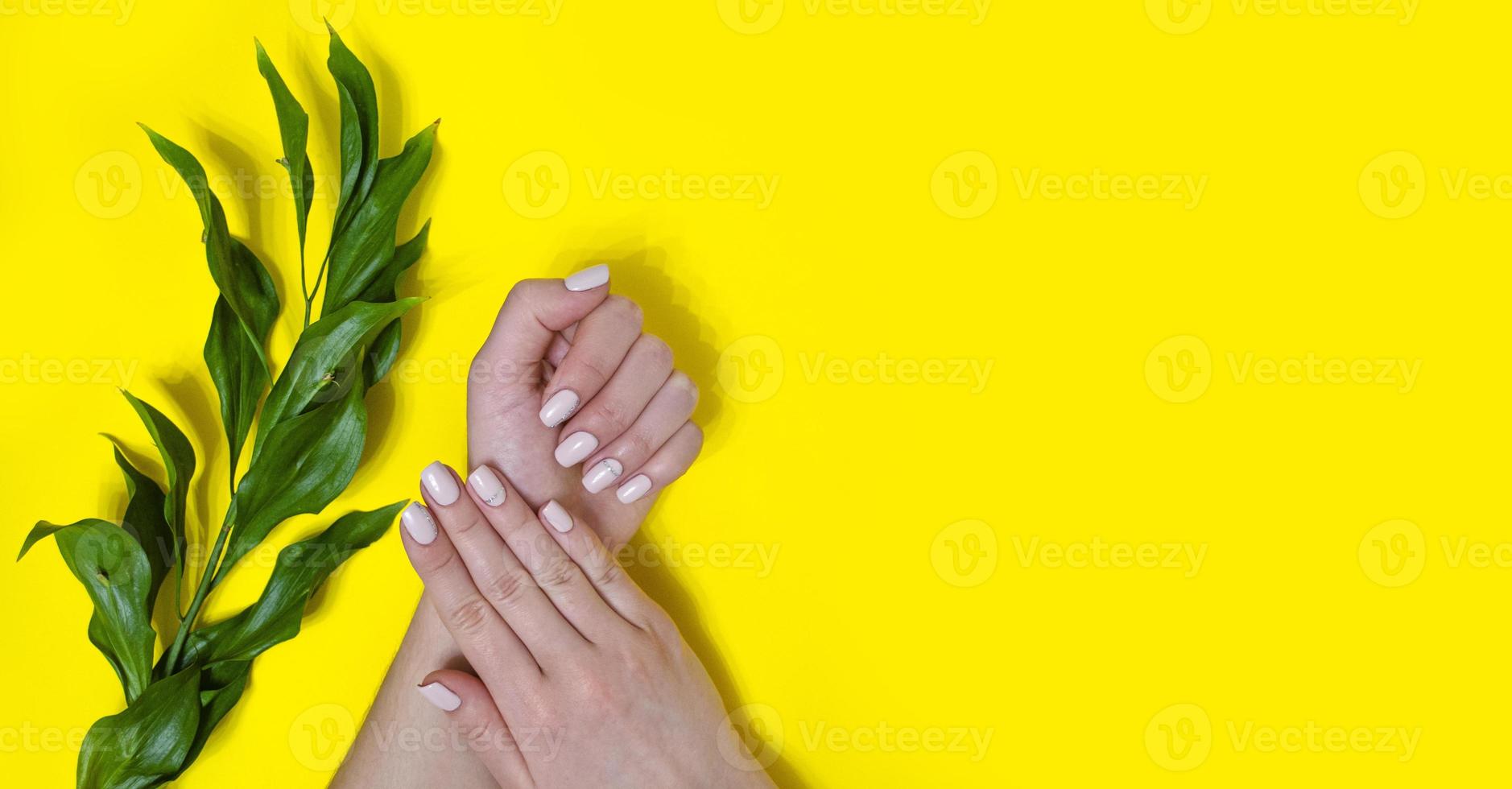 manicura femenina sobre un fondo brillante. amarillo foto