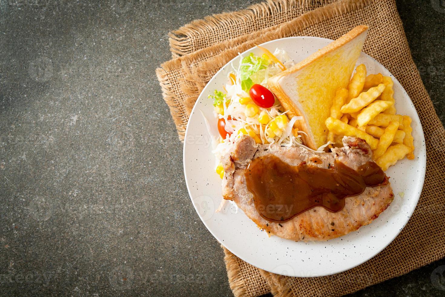 Pork steak with black peppers gravy sauce and mini salad photo