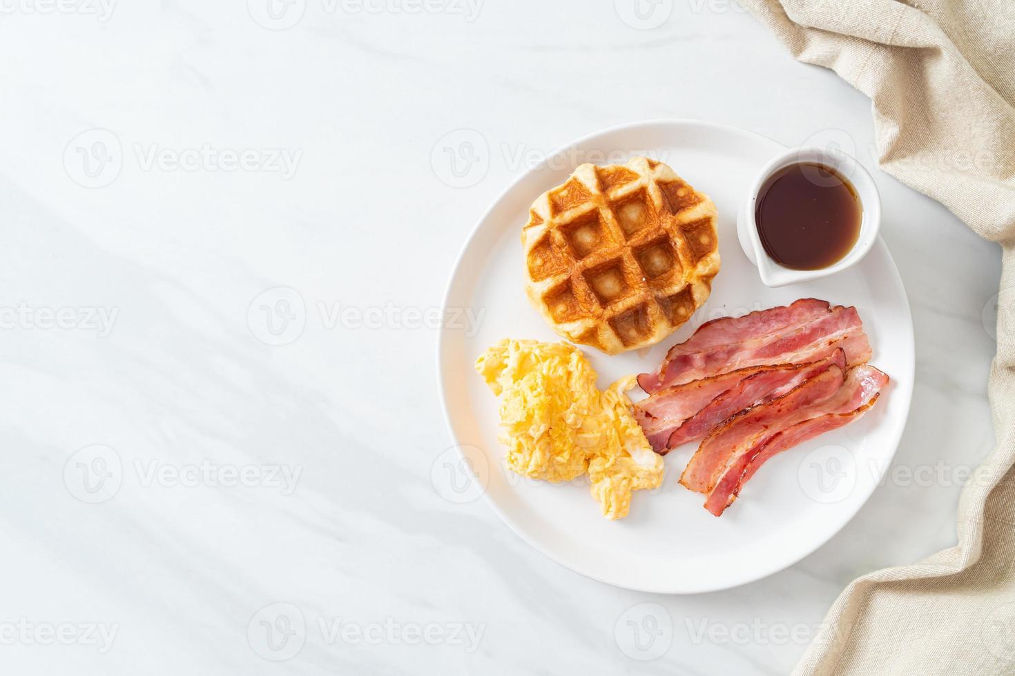 Scrambled egg with bacon and waffle for breakfast photo