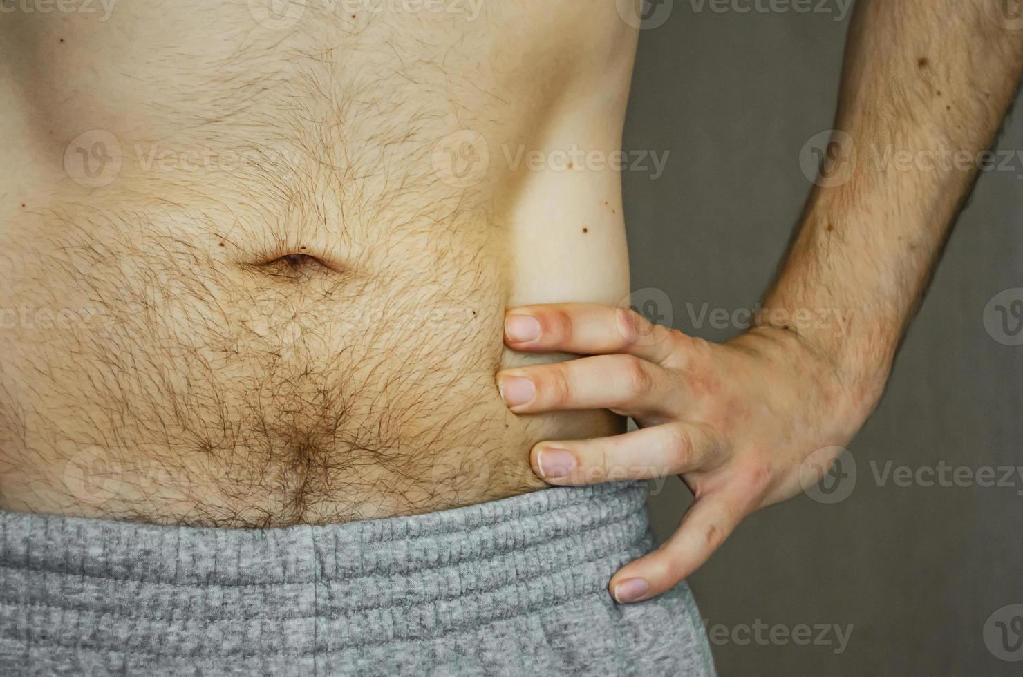 The hairy belly of a young man. photo