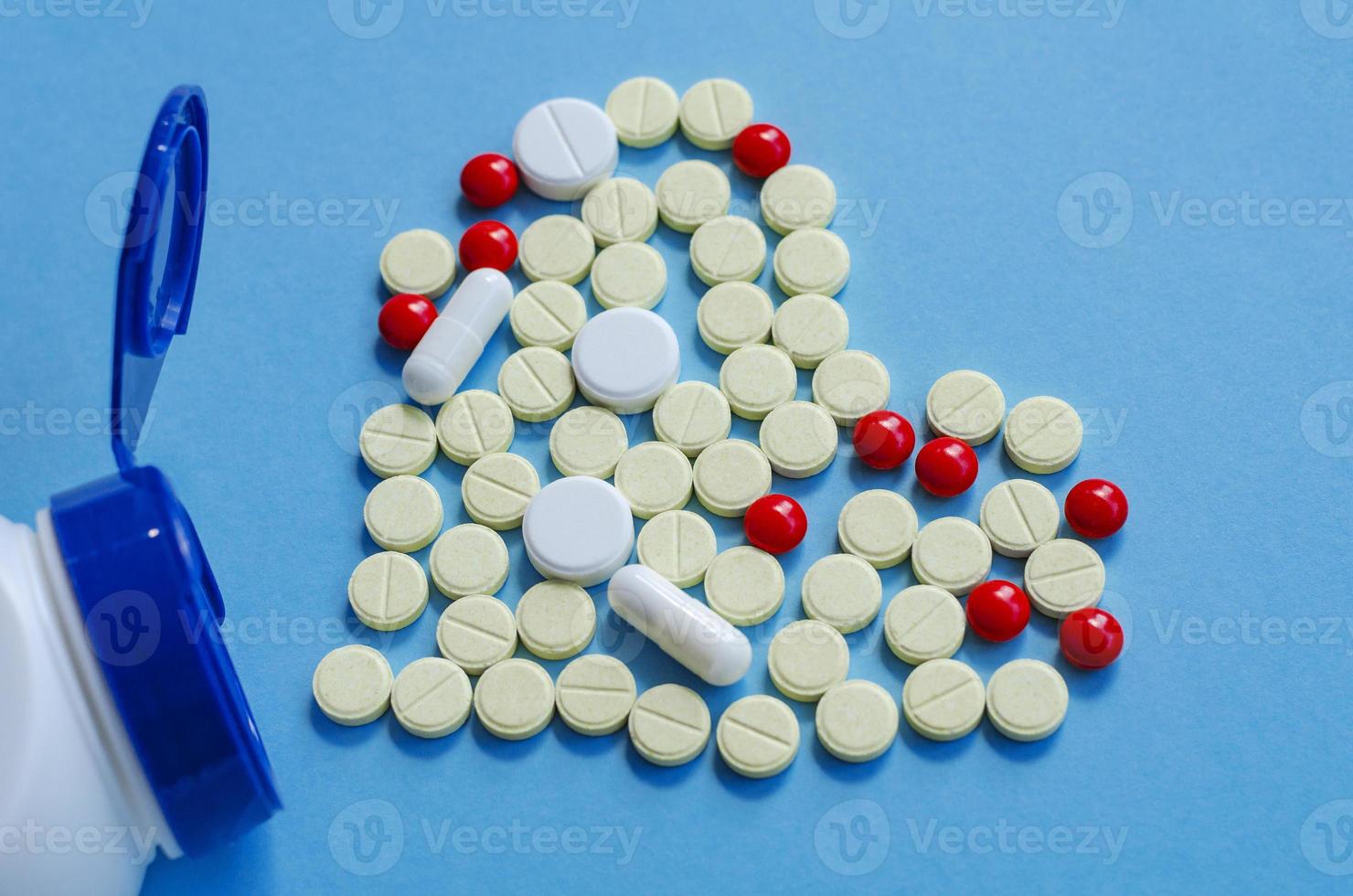 White heart pills on a colored background. photo