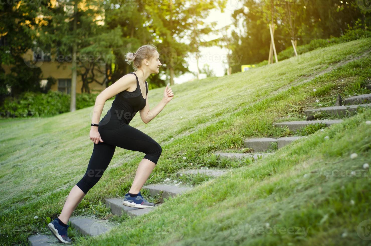 The girl runs up the stairs. Healthy lifestyle. photo