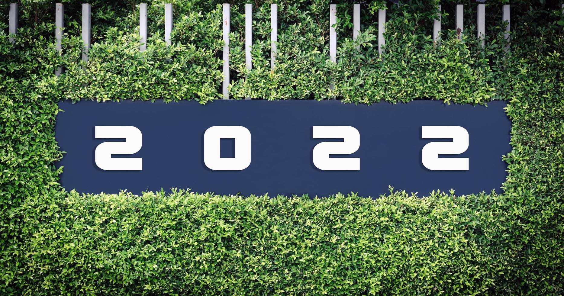 Number 2022 logo on the framed by green leaves. photo