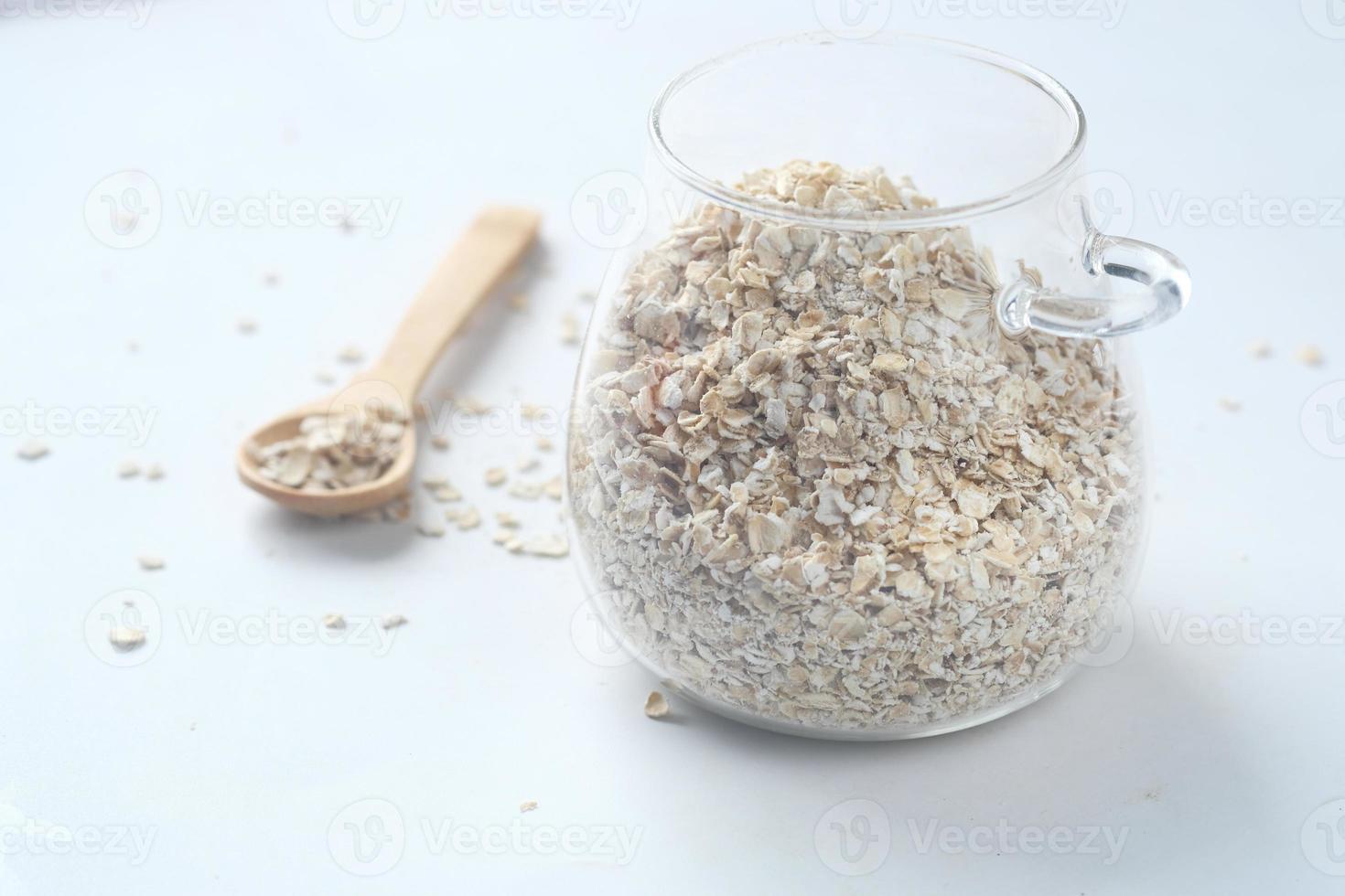 oats flakes in a jar with spoon on table photo