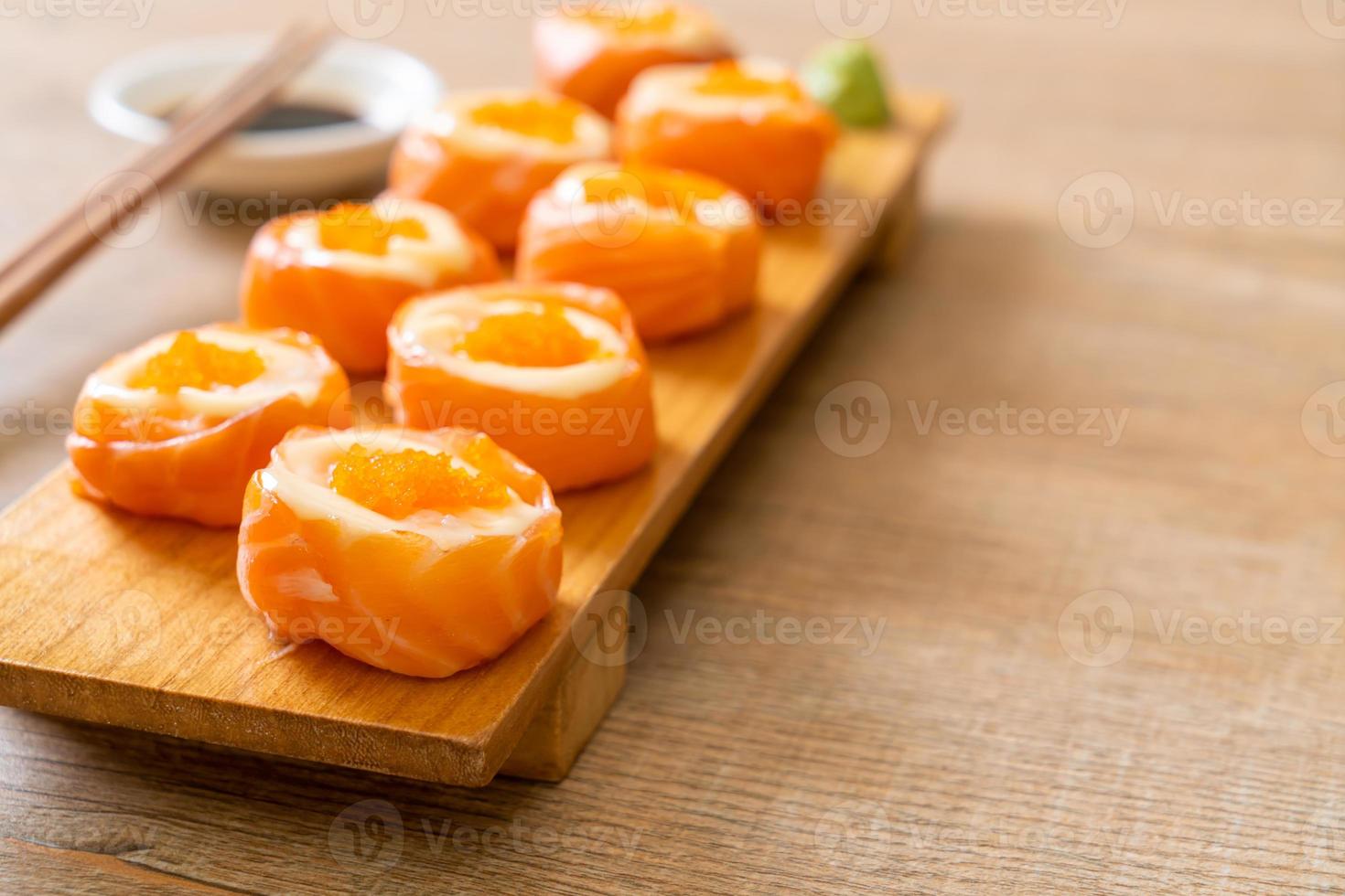 Fresh salmon sushi roll with mayonnaise and shrimp egg - Japanese food style photo