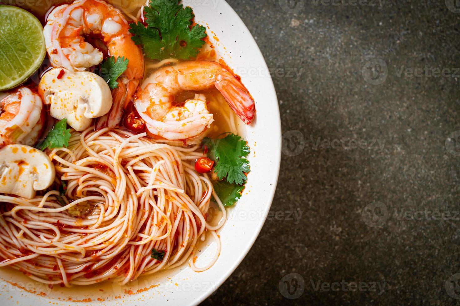 Noodles with spicy soup and shrimps in white bowl - Tom Yum Kung - Asian food style photo