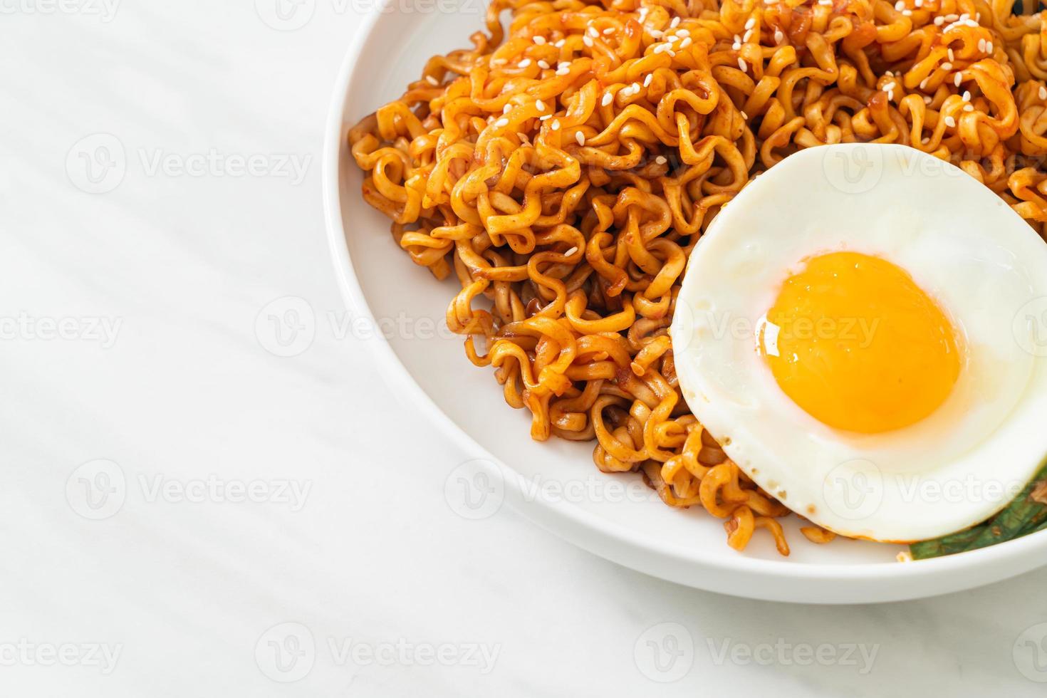 Homemade dried Korean spicy instant noodles with fried egg photo