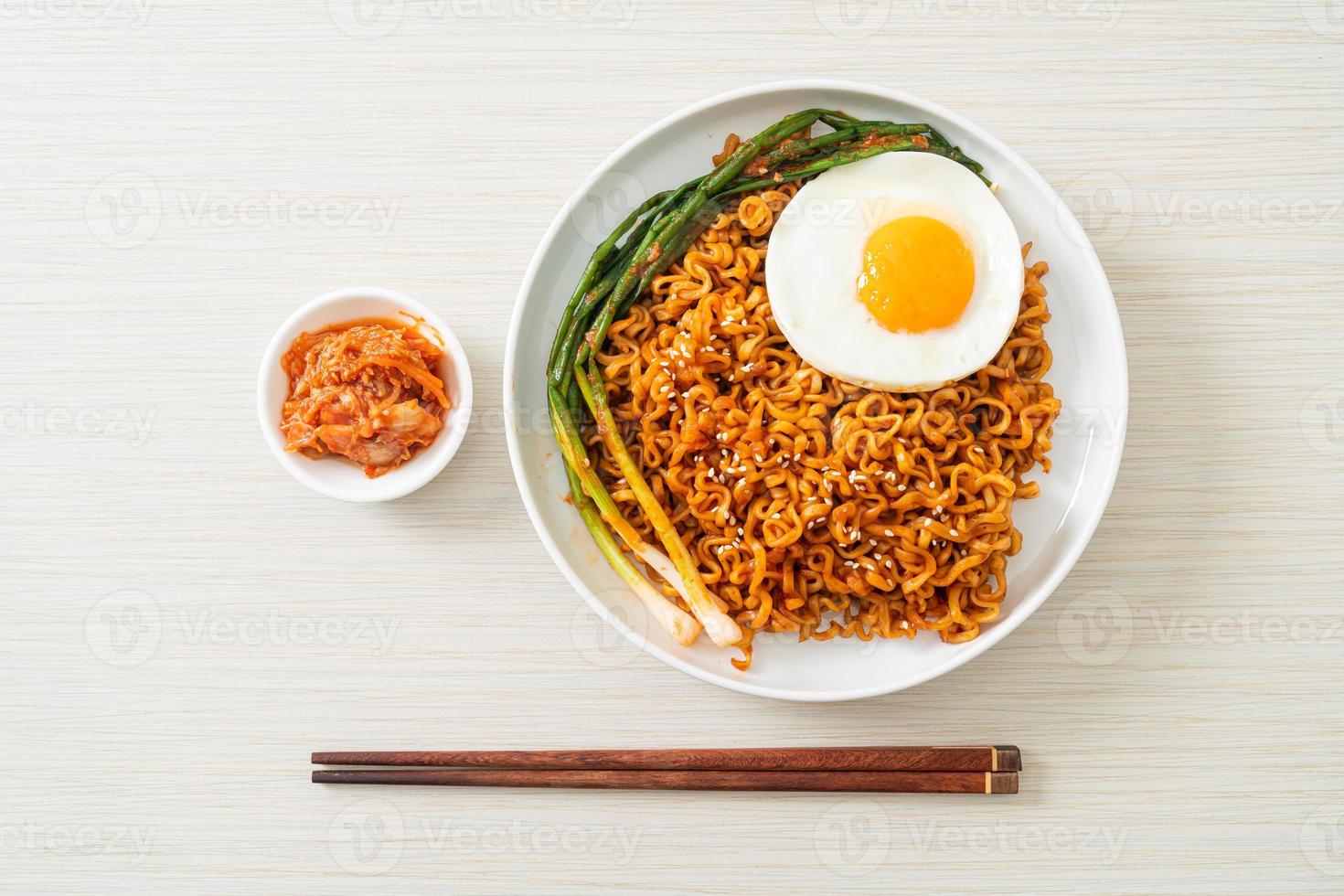 Homemade dried Korean spicy instant noodles with fried egg photo