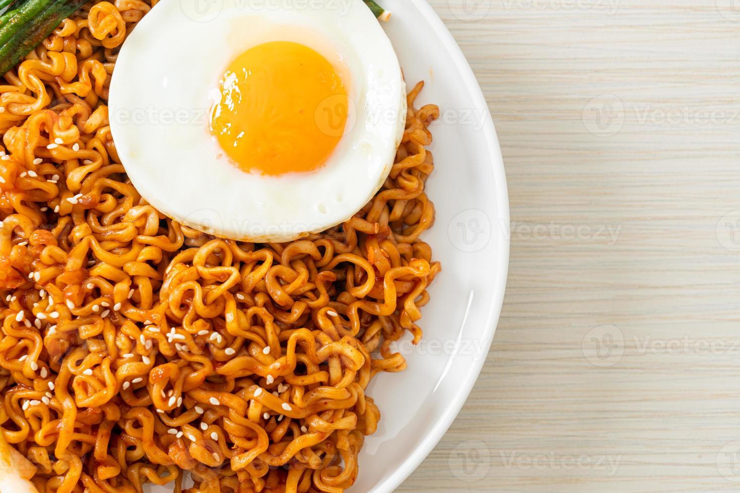 Homemade dried Korean spicy instant noodles with fried egg photo