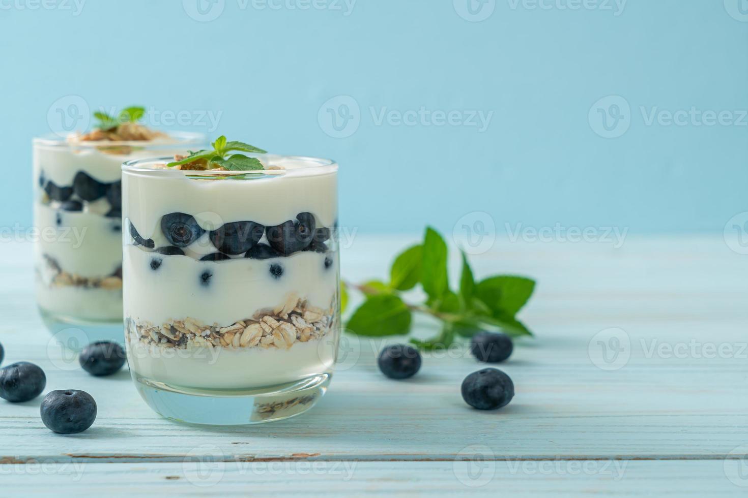 Fresh blueberries and yogurt with granola - Healthy food style photo