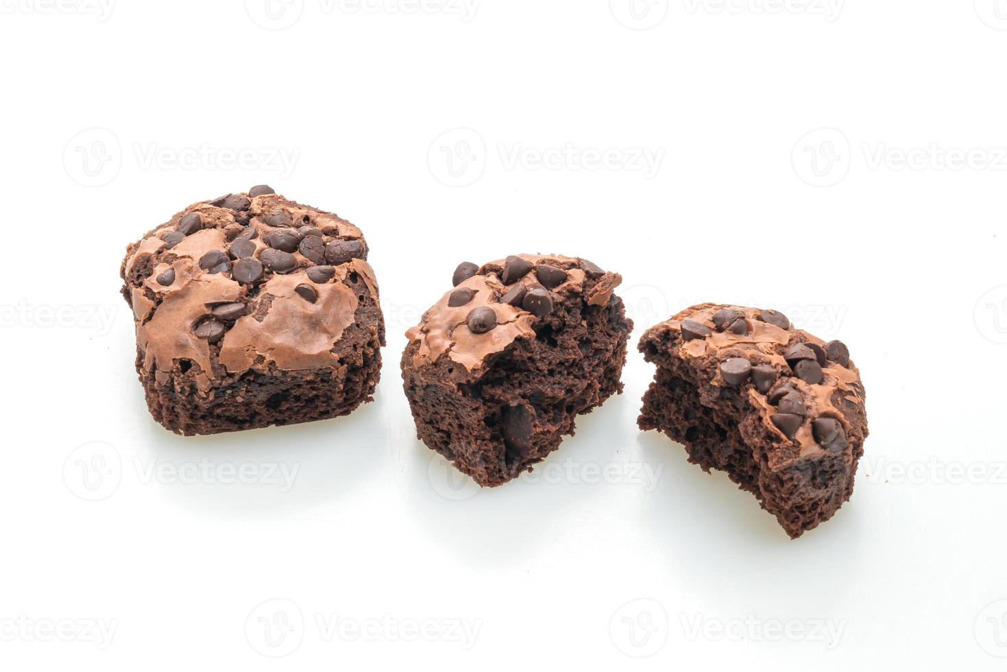 Dark chocolate brownies topped by chocolate chips isolated on white background photo